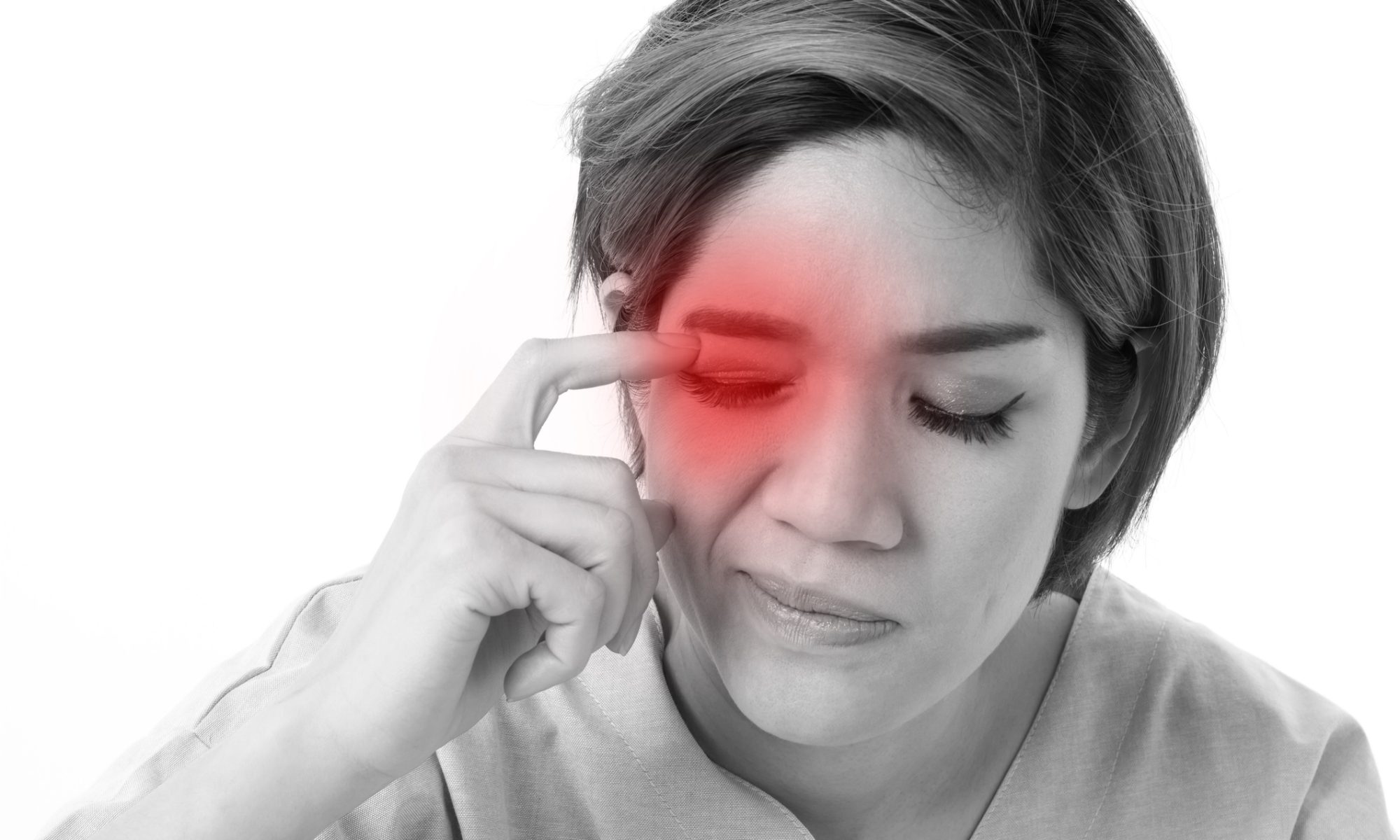 A woman touches the area above her eye with a pained expression, with a red highlight indicating inflammation or neuropathic eye pain.