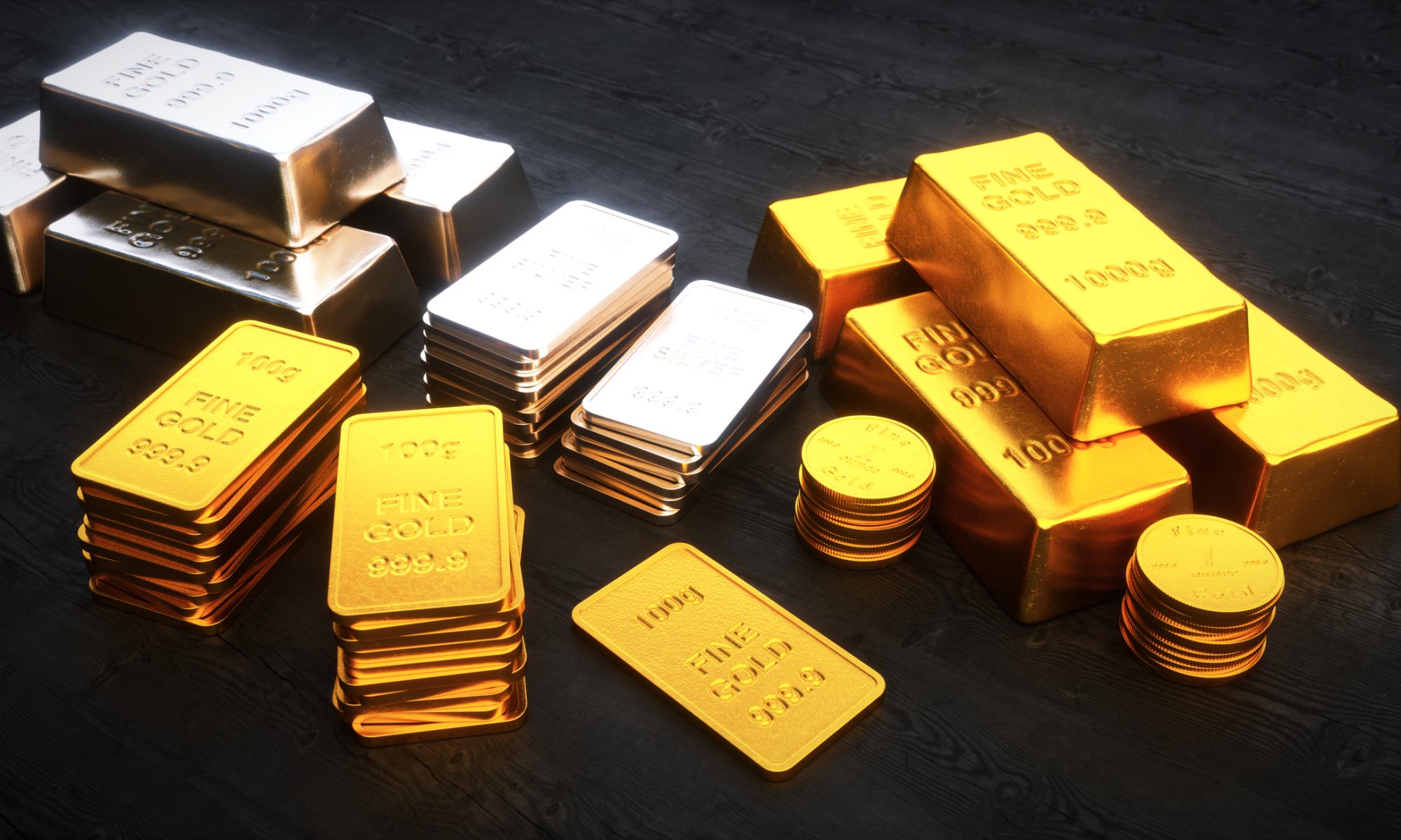 Stacks of gold and silver bullion bars and coins displayed on a dark surface, representing precious metals investment and safe-haven assets.