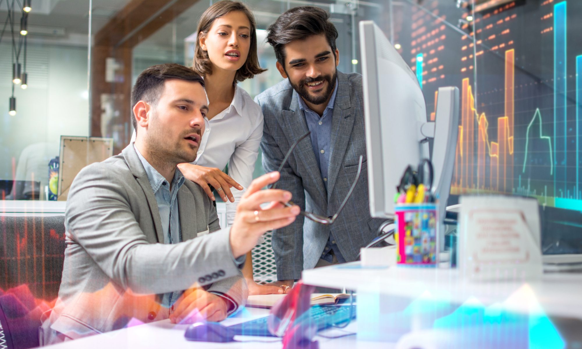 Business professionals analyzing real-time market data on a computer screen, highlighting intraday stock movement and sector performance.