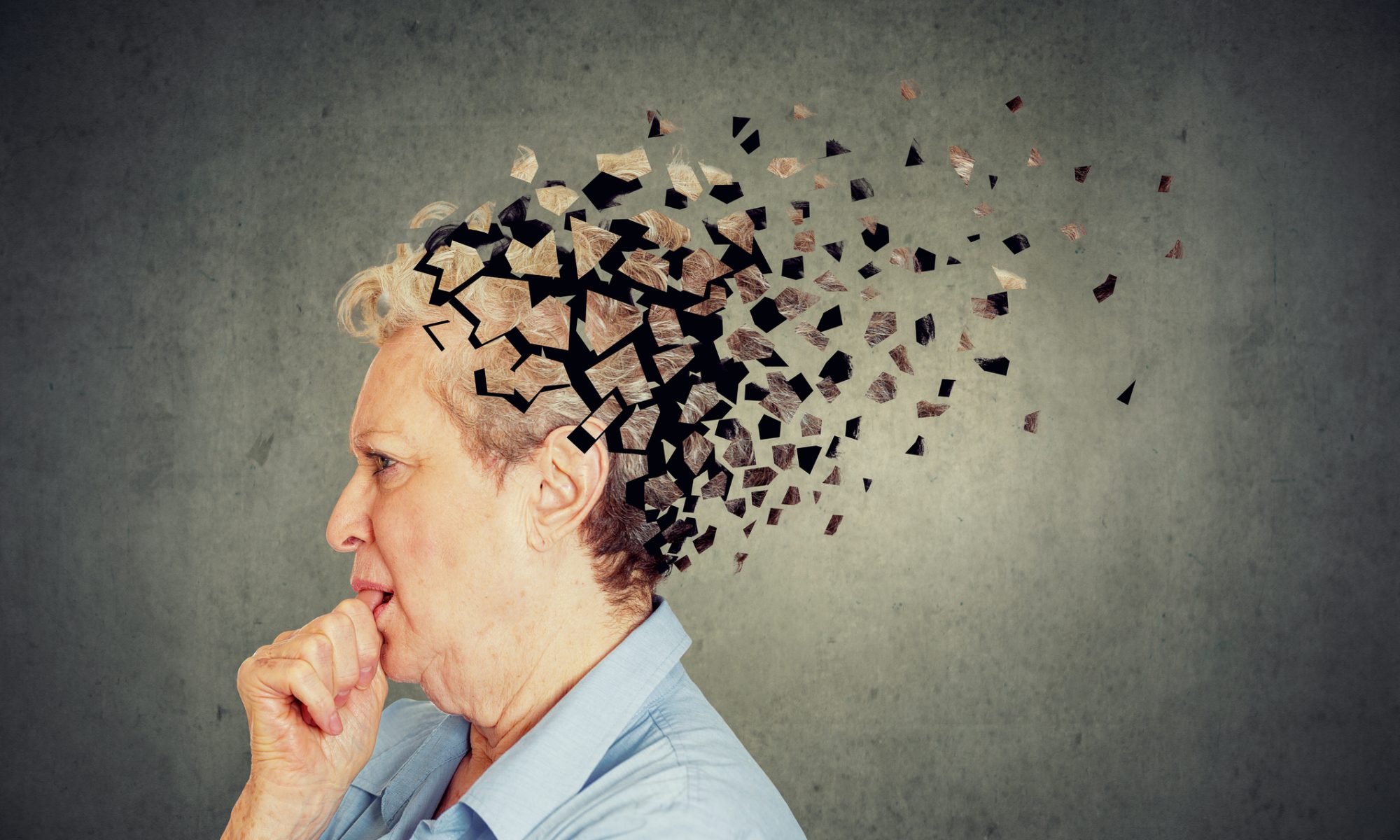 Conceptual image of an older woman with fragmented shapes emerging from her head, symbolizing cognitive decline associated with Alzheimer’s disease.