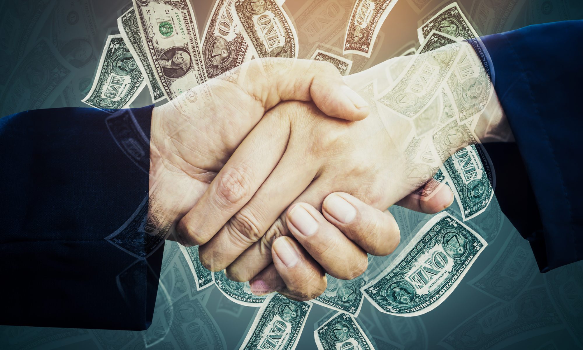 Two business professionals shaking hands with U.S. dollar bills overlaid, symbolizing a completed bank merger and large-scale financial transaction.