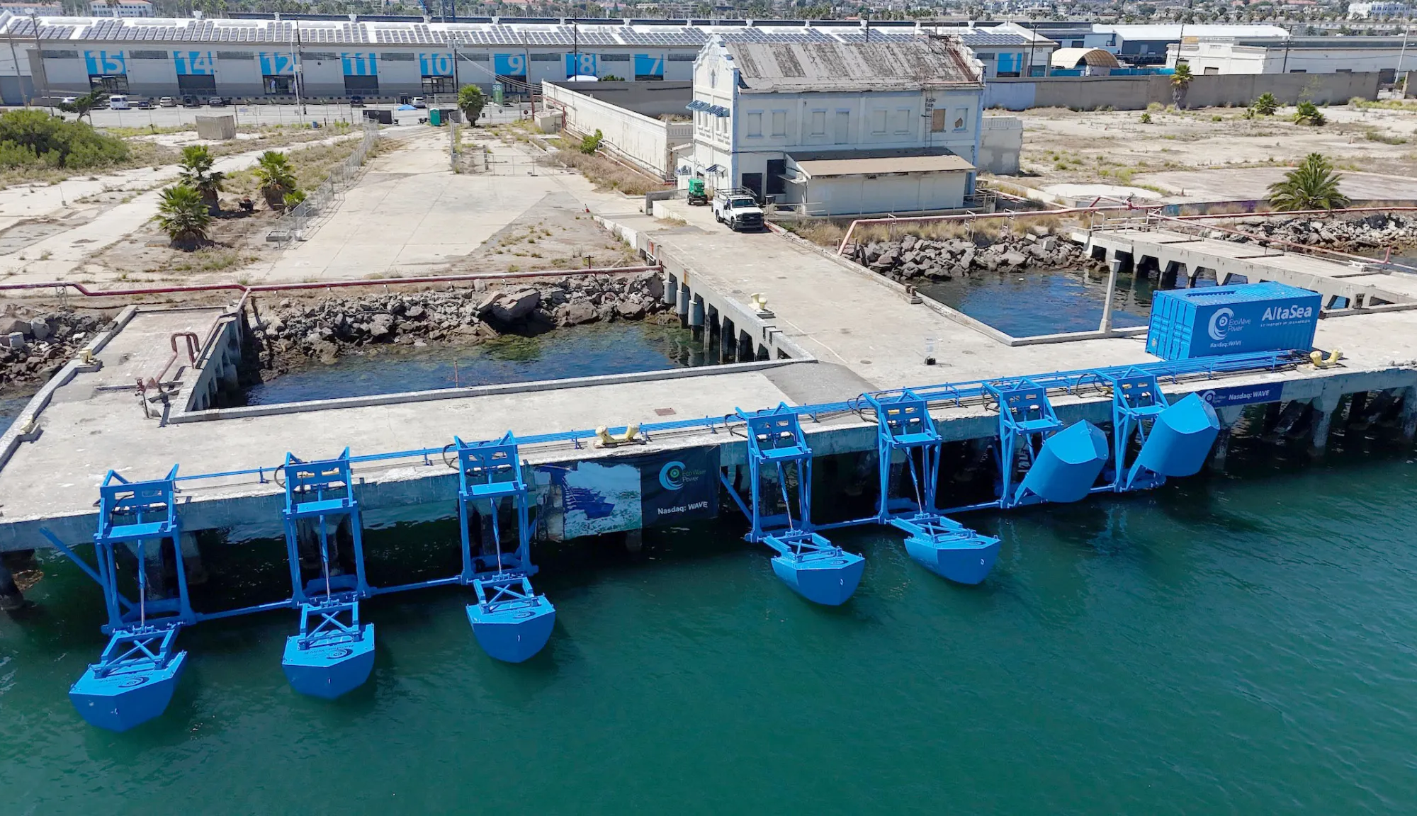 Eco Wave Power’s blue wave energy conversion units mounted along a coastal pier, designed to capture ocean wave motion and convert it into renewable electricity.