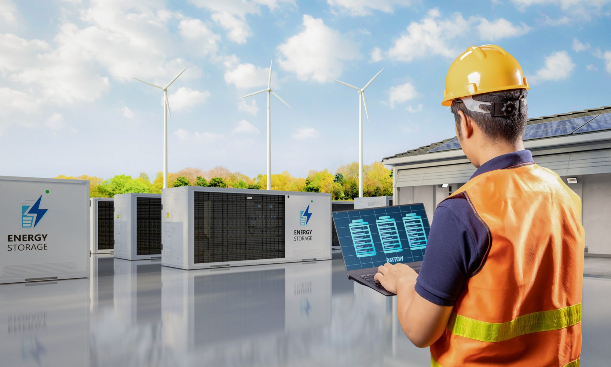 Technician monitoring battery energy storage units with wind turbines in the background, representing on-site renewable energy storage and grid optimization.