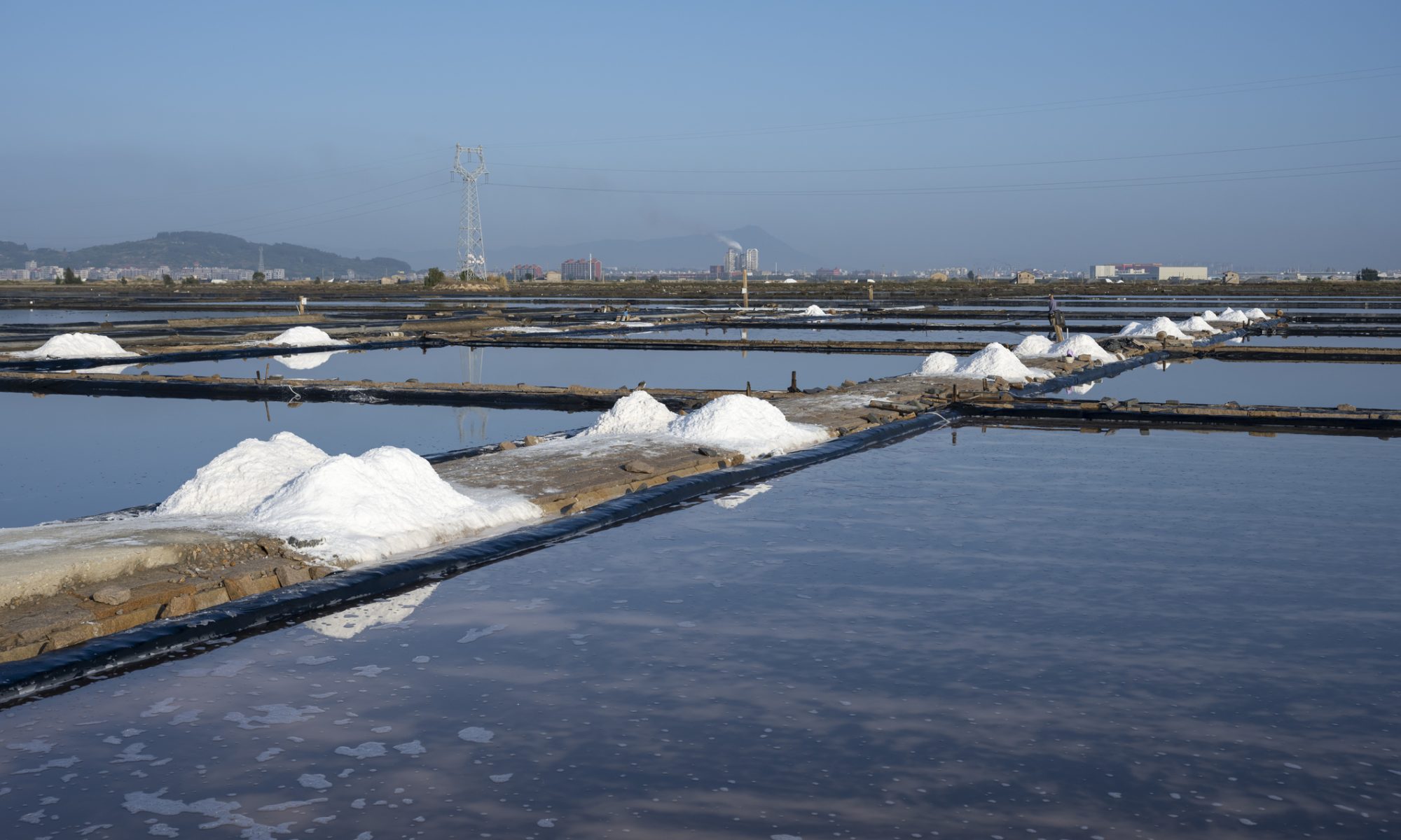 Salt evaporation ponds used for mineral extraction, representing lithium brine processing and critical battery material production.