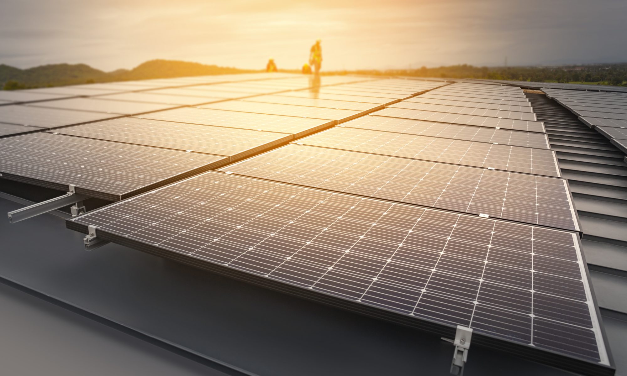 Rows of solar panels installed on a rooftop capturing sunlight for renewable energy generation.