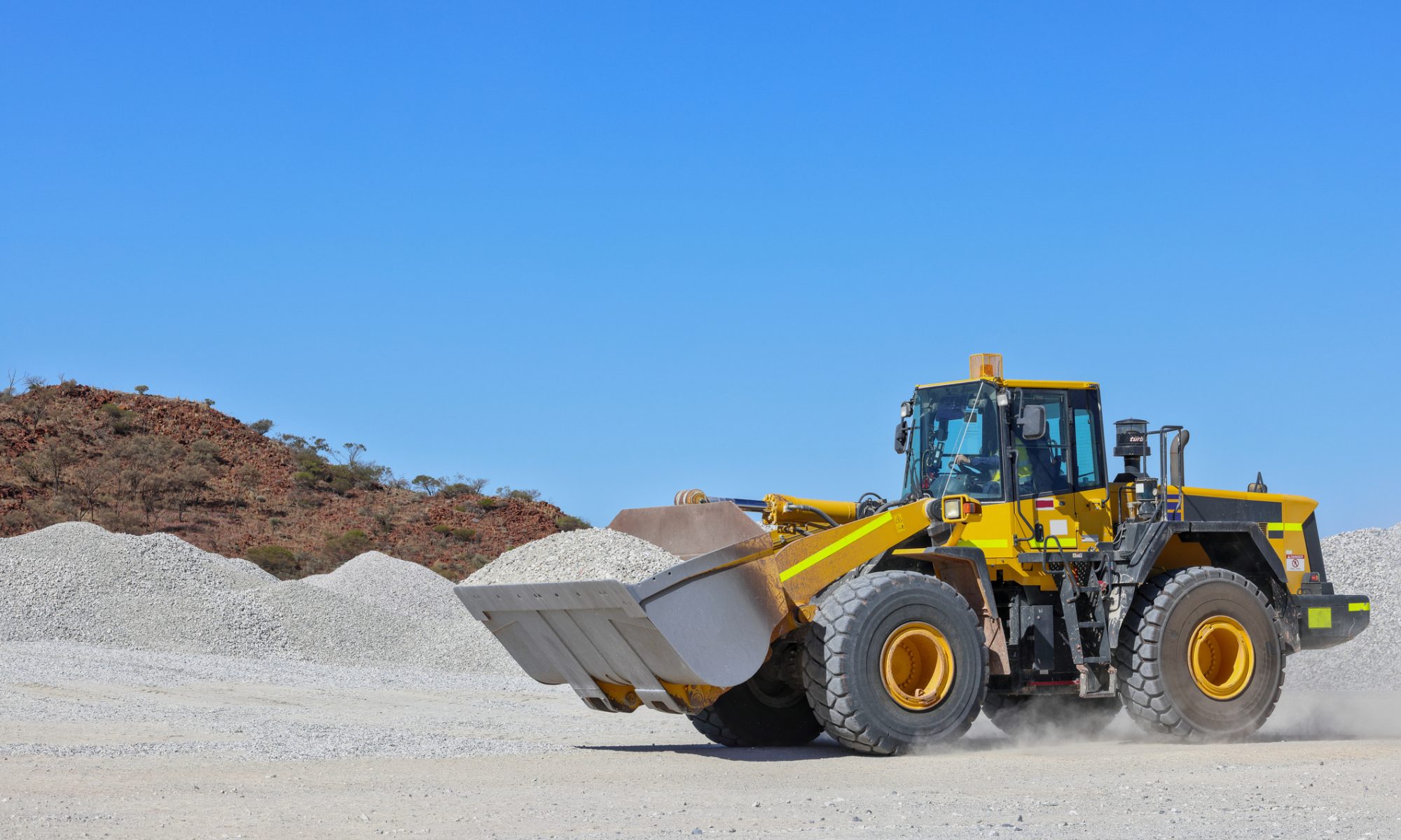 Heavy machinery operating in a mining site, representing raw material extraction used in battery production.