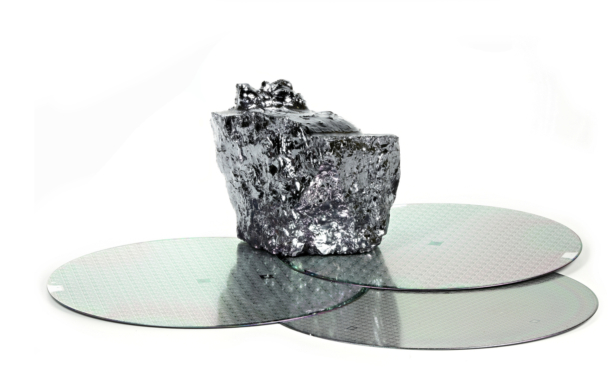 A polished silicon carbide (SiC) crystal sits atop three silicon wafers, symbolizing semiconductor innovation and next-generation power electronics used in electric vehicles, renewable energy systems, AI infrastructure, and industrial high-voltage applications.