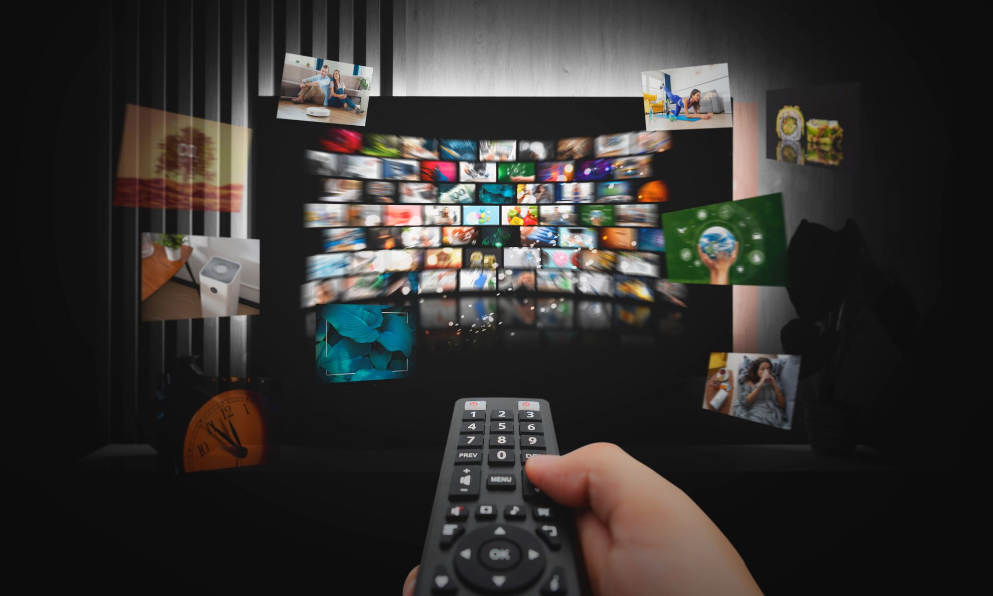 A person holds a television remote while browsing a streaming service interface displaying live television and entertainment content on a large screen.