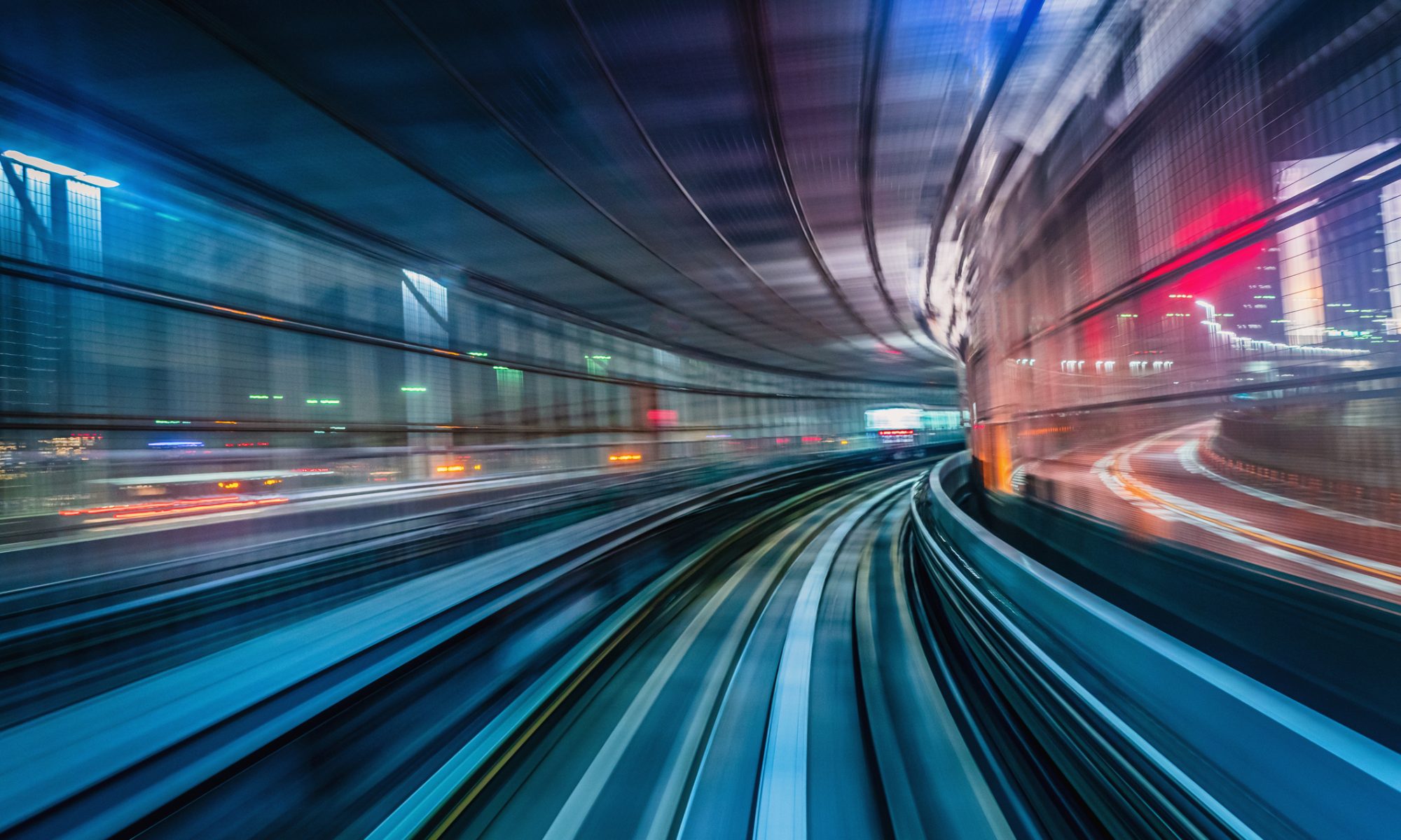 High-speed rail tracks moving through a modern urban environment, representing Duos Technologies Group’s sale of its rail technology business and strategic shift toward edge AI and data center infrastructure.
