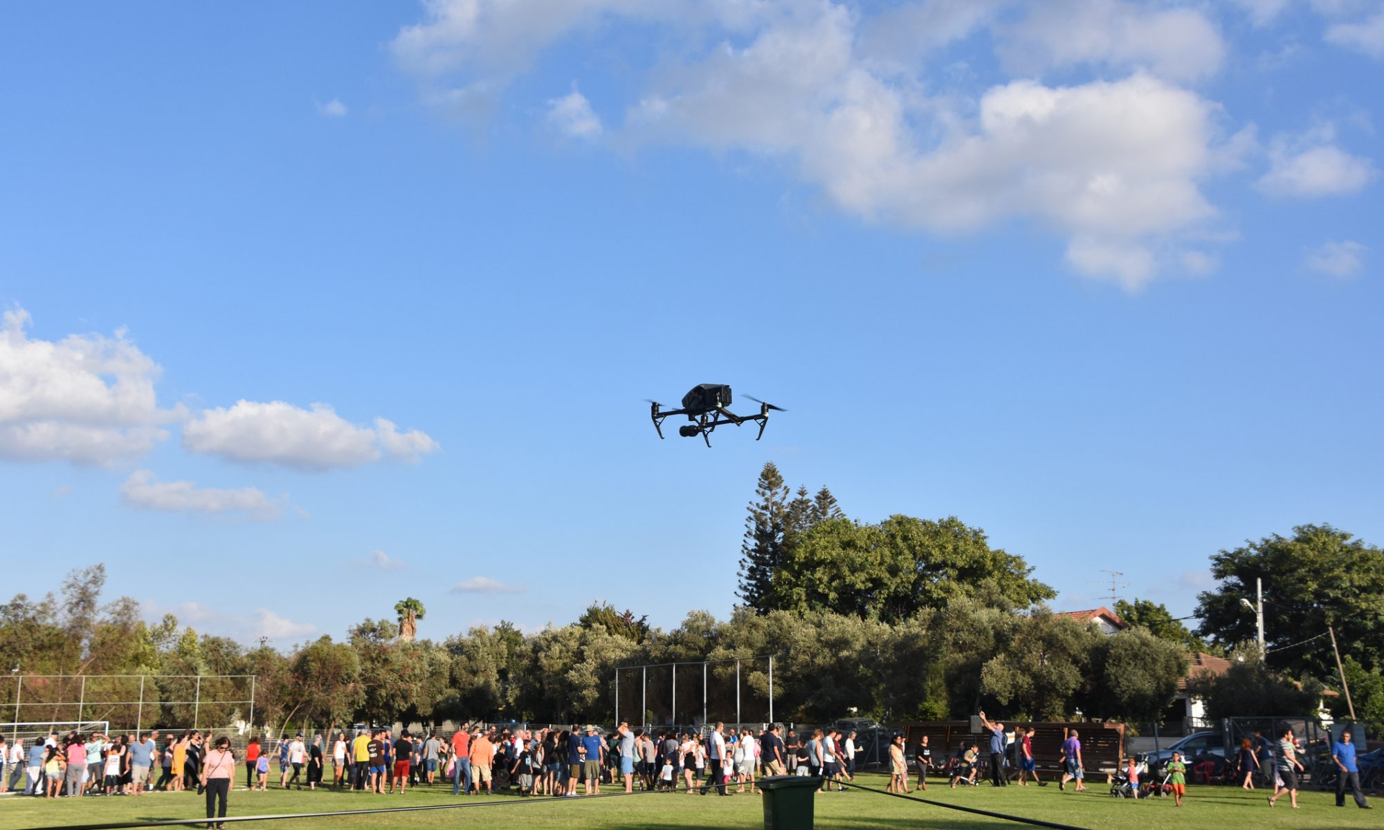 Drone flying above a community gathering, representing Red Cat Holdings’ partnership with the Washington Commanders to support active-duty service members, veterans, and military families.