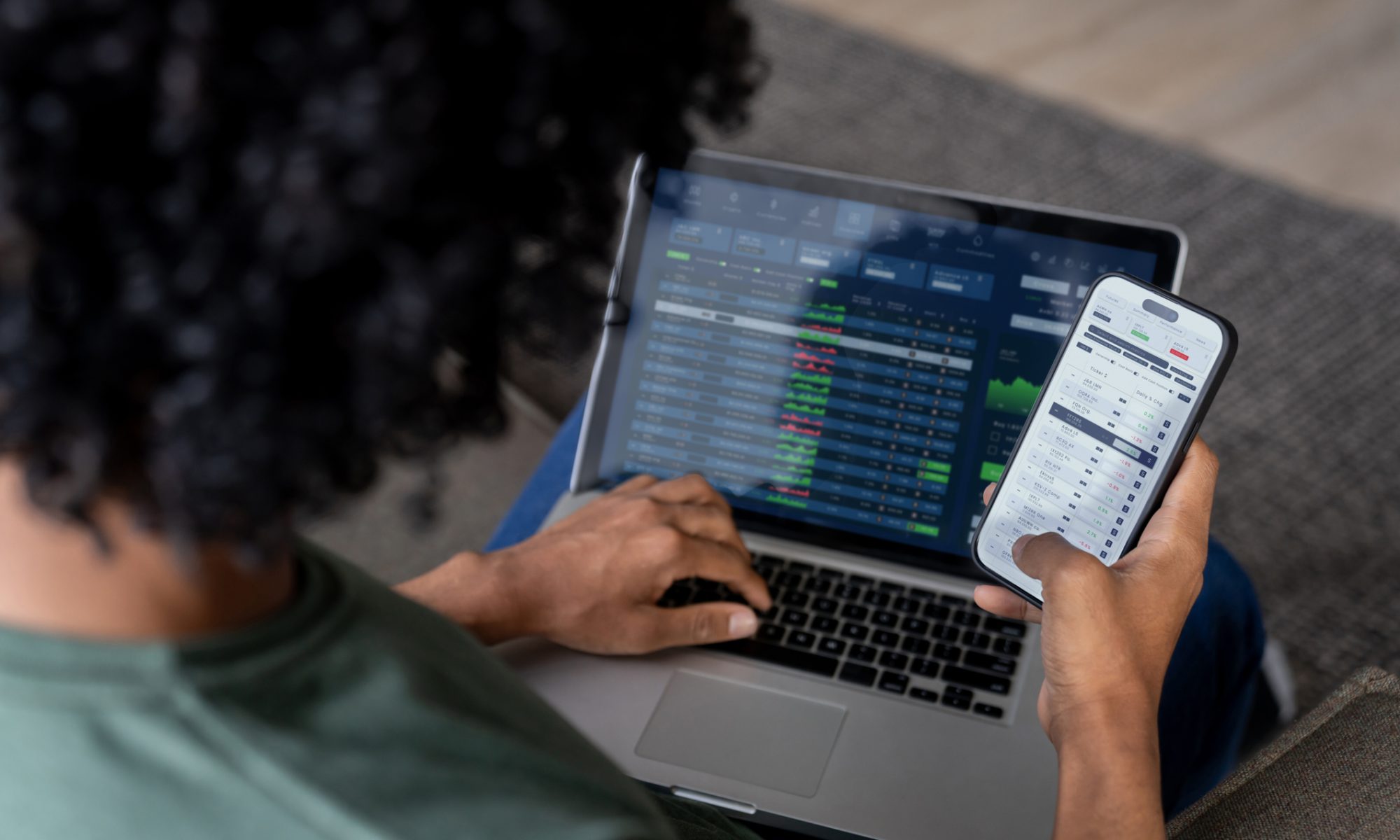 Investor monitoring stock prices on a laptop and smartphone, representing strong mid-day gains in 5E Advanced Materials, Silence Therapeutics, Innate Pharma, and AgEagle Aerial Systems.
