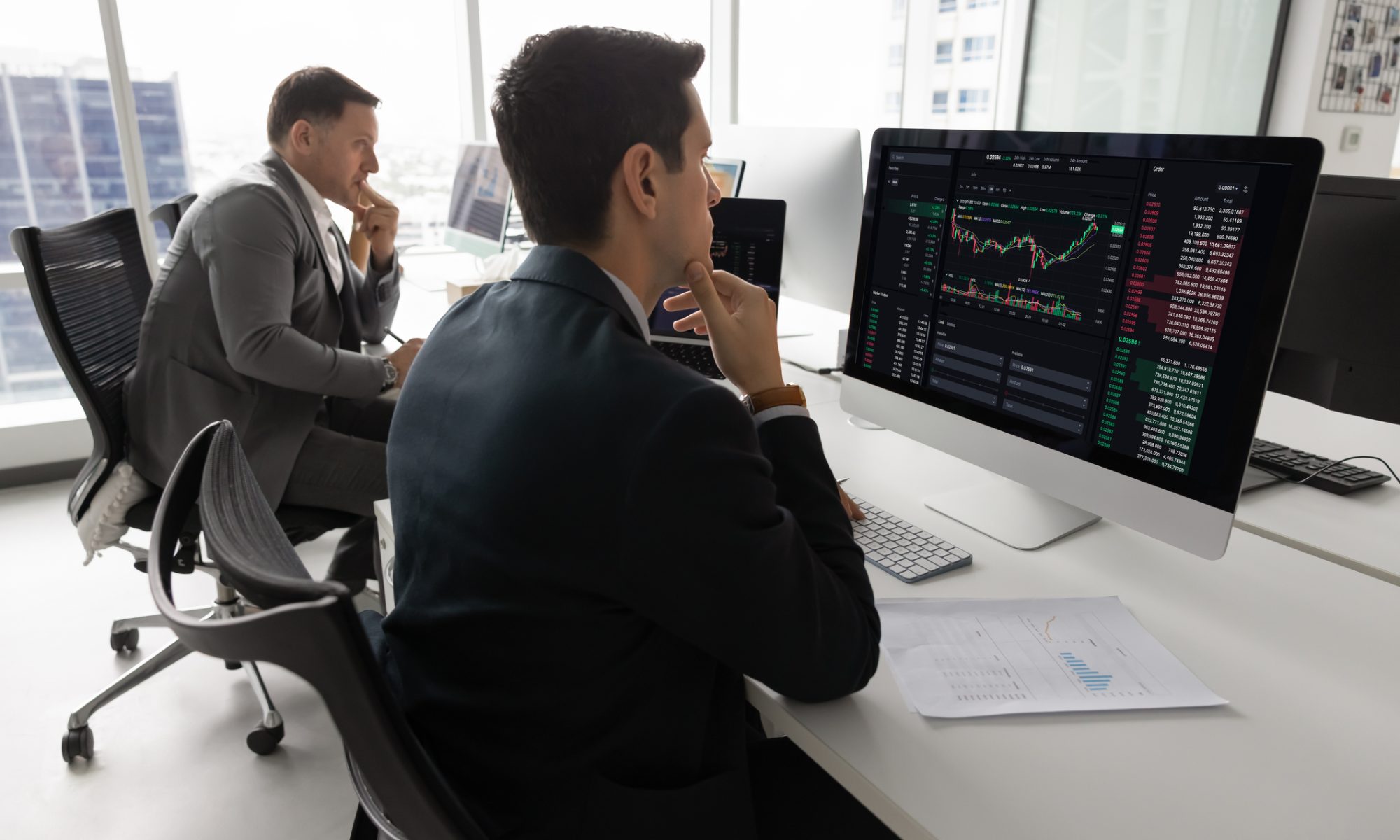 Traders monitoring stock charts and market data on computer screens, representing PRISM Mid-Day Movers led by Dogness and GrowGeneration.
