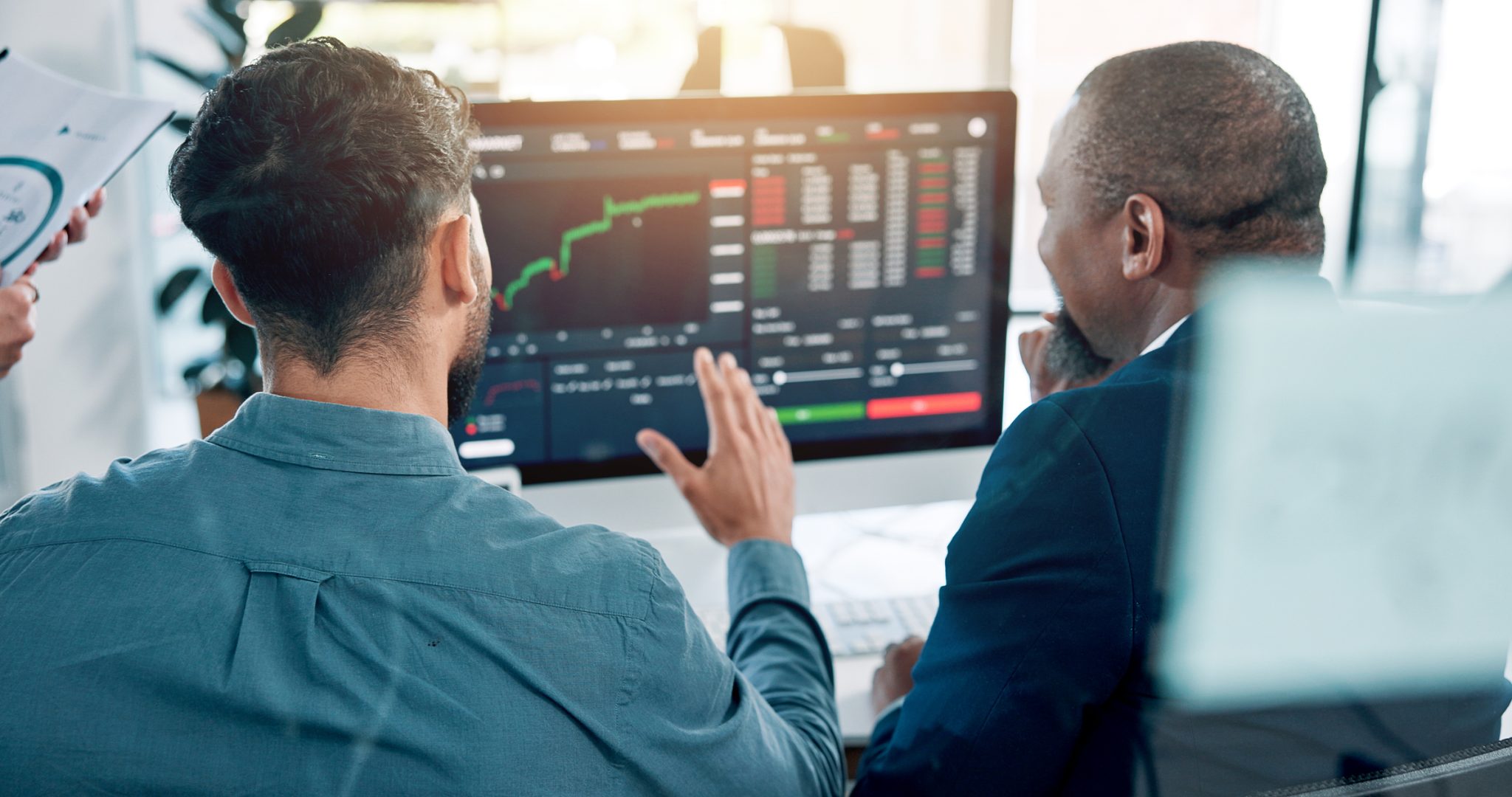 Market professionals monitor a rising stock chart, representing active trading in Rare Element Resources, CuriosityStream and other PRISM Mid-Day Movers.