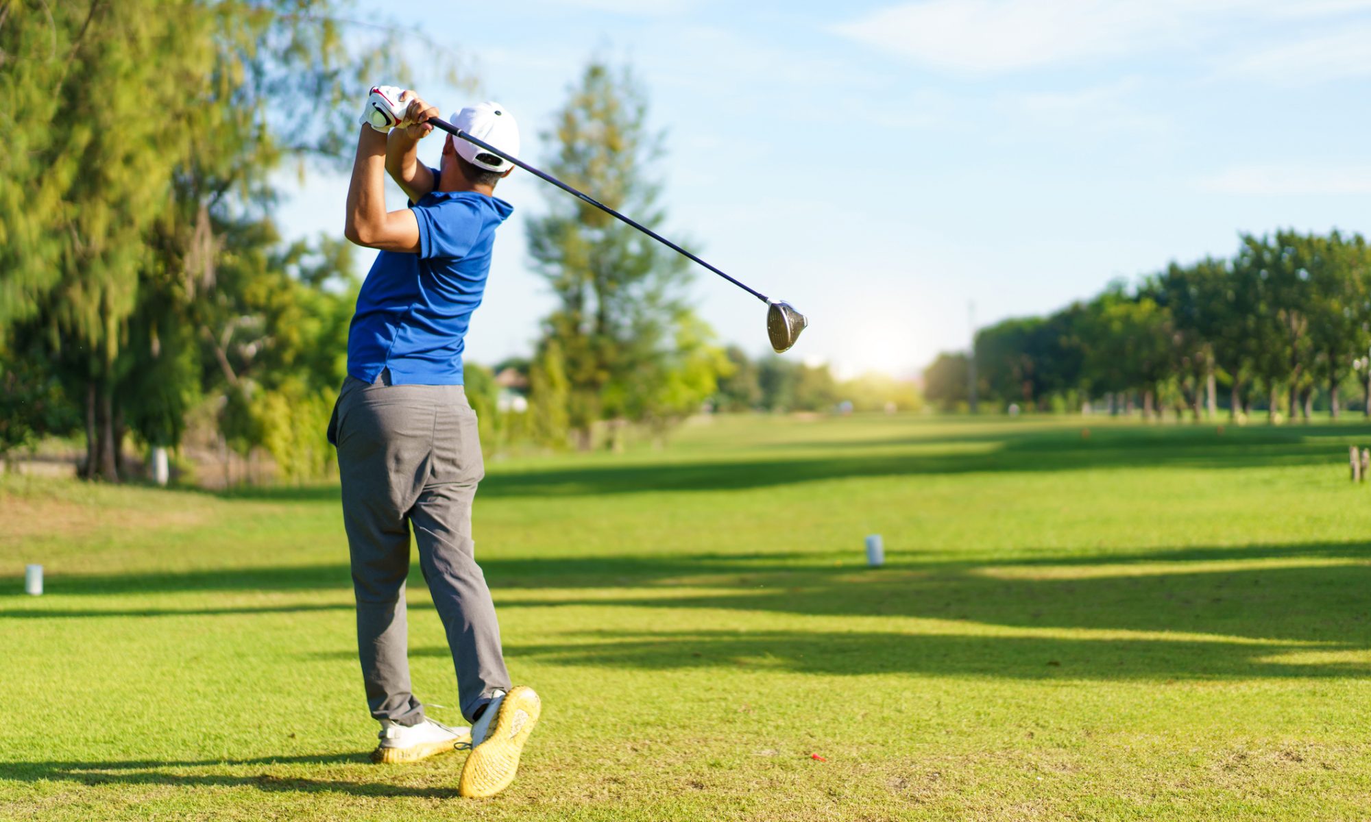 Golfer completing a drive on a sunny golf course, representing Newton Golf’s next-generation shaft products and expanding adoption among professional players.
