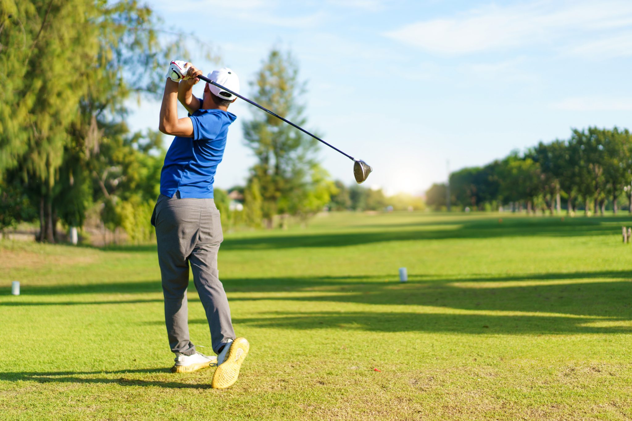 Golfer completing a drive on a sunny golf course, representing Newton Golf’s next-generation shaft products and expanding adoption among professional players.