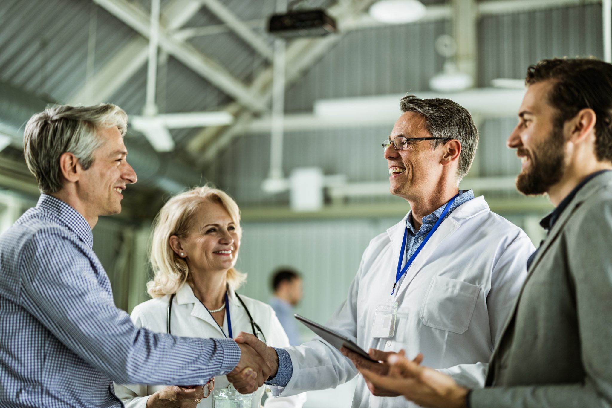 Biotechnology executives and researchers meeting in a laboratory setting, representing Skye Bioscience’s planned acquisition of Redx Pharma and the formation of Fibrx Therapeutics.