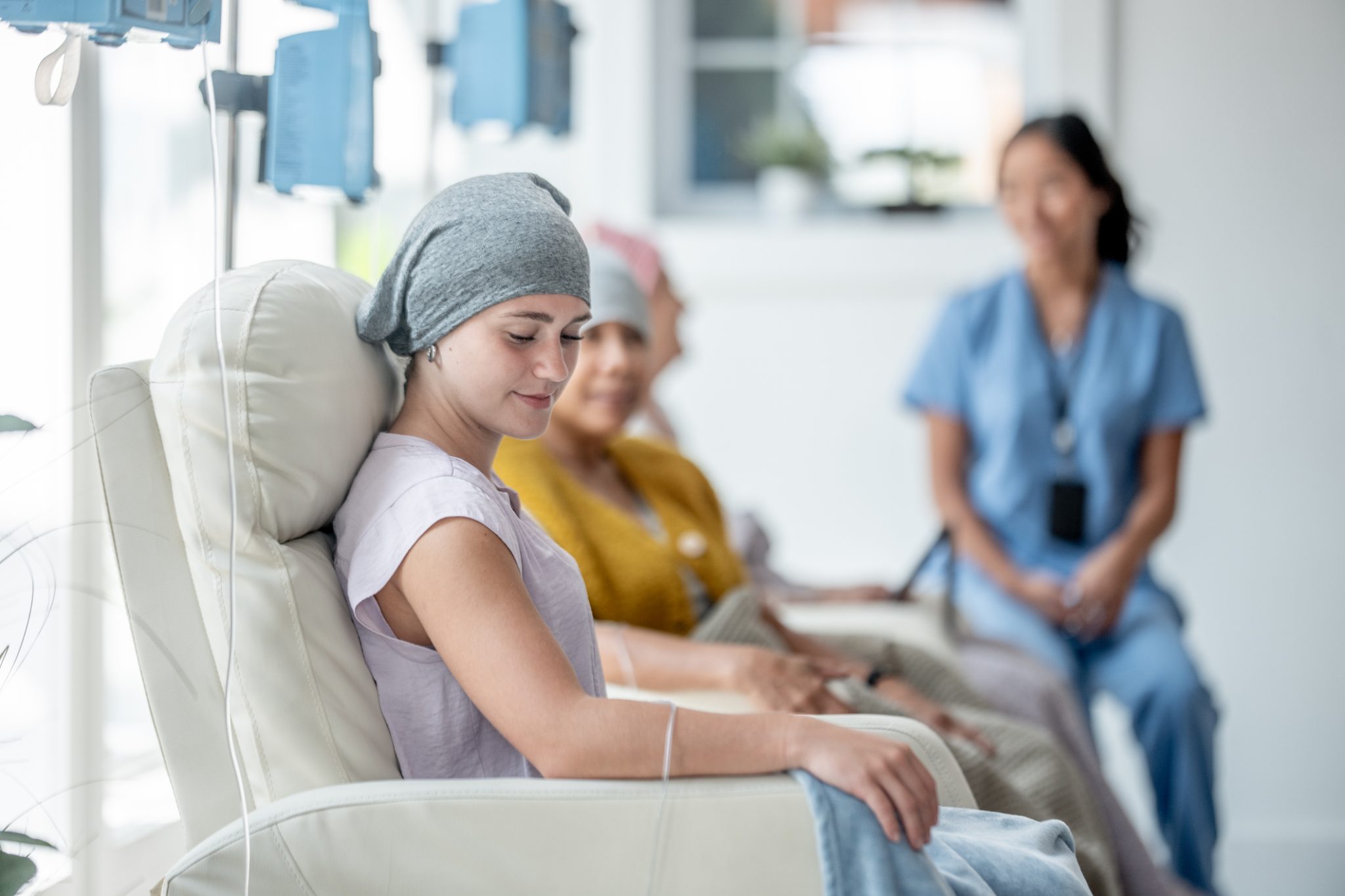 Cancer patients receiving infusion treatment in an oncology clinic, representing clinical research and new therapies for advanced endometrial cancer.
