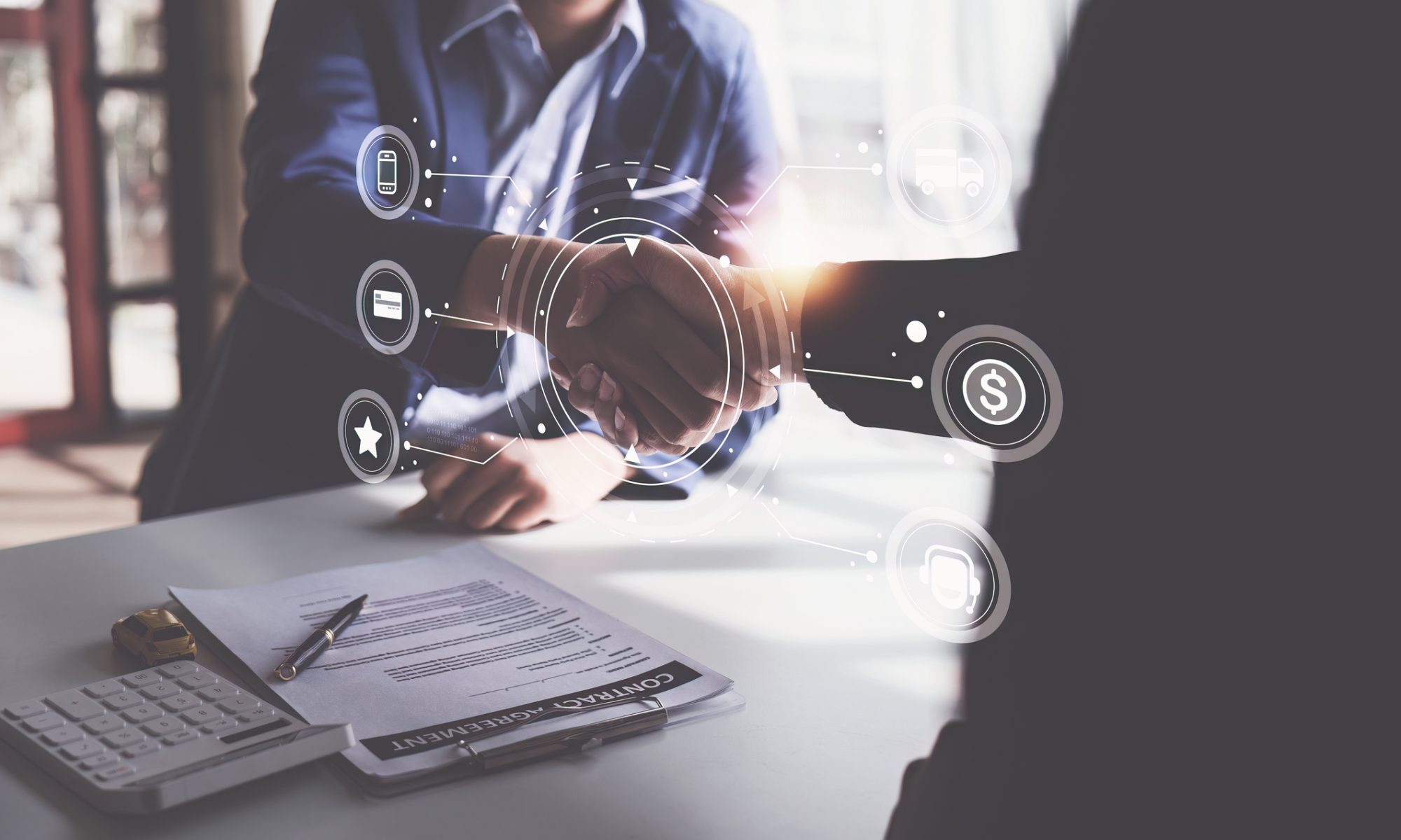 Business professionals shake hands over a contract with digital finance and transaction icons, representing Teva’s proposed acquisition of BioXcel Therapeutics’ IGALMI and BXCL501 assets.