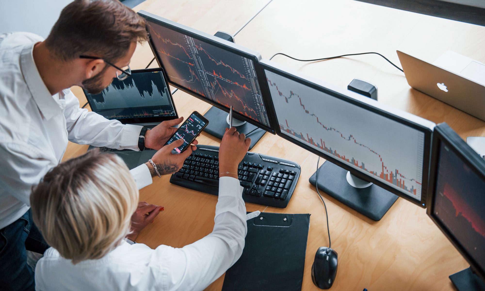 Market professionals monitor stock charts across multiple screens, illustrating volatile mid-day trading as PRISM Beauty & Wellness and Consumer Products indexes lead the market.