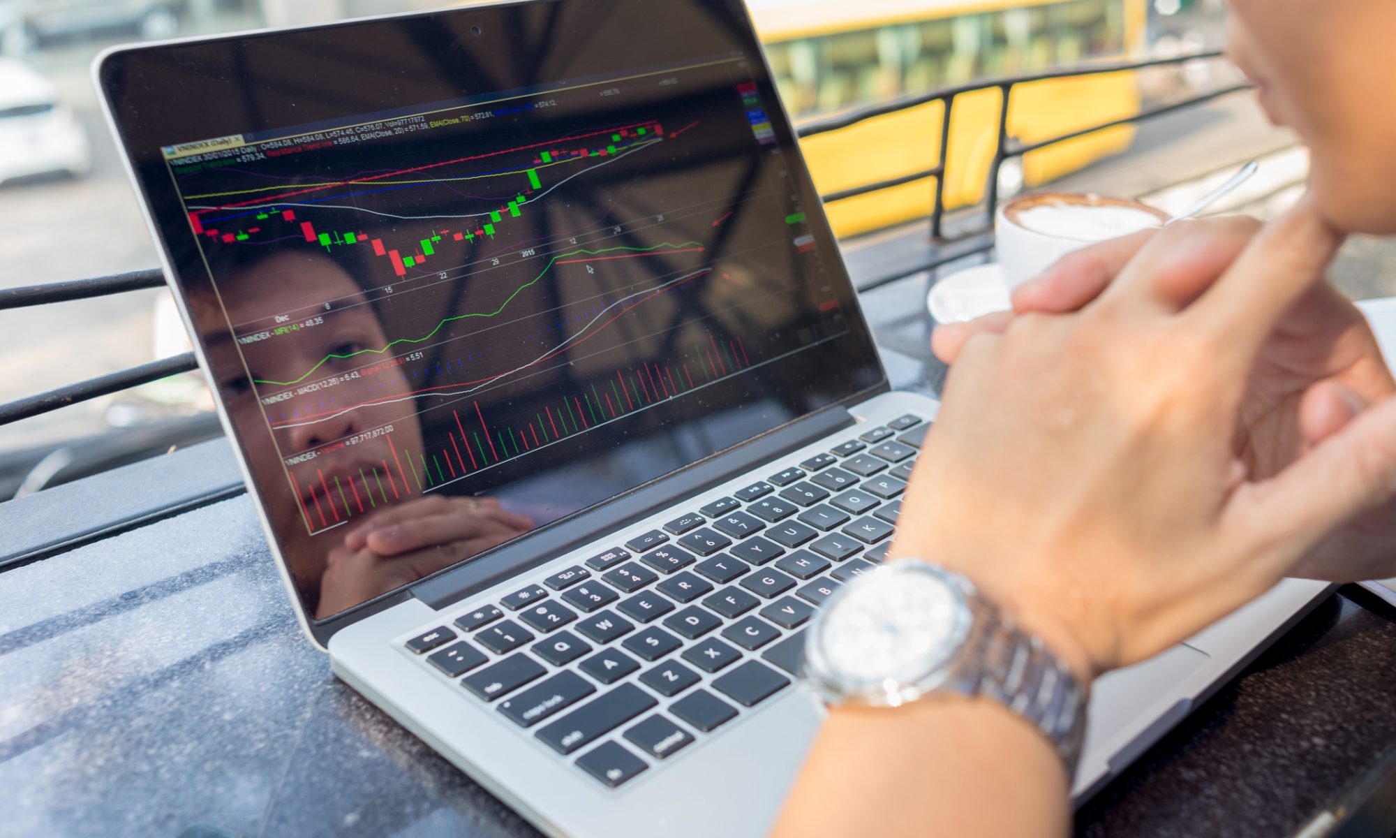 Investor monitoring stock charts on a laptop, representing active midday trading and sharp moves across MedTech and new energy stocks.