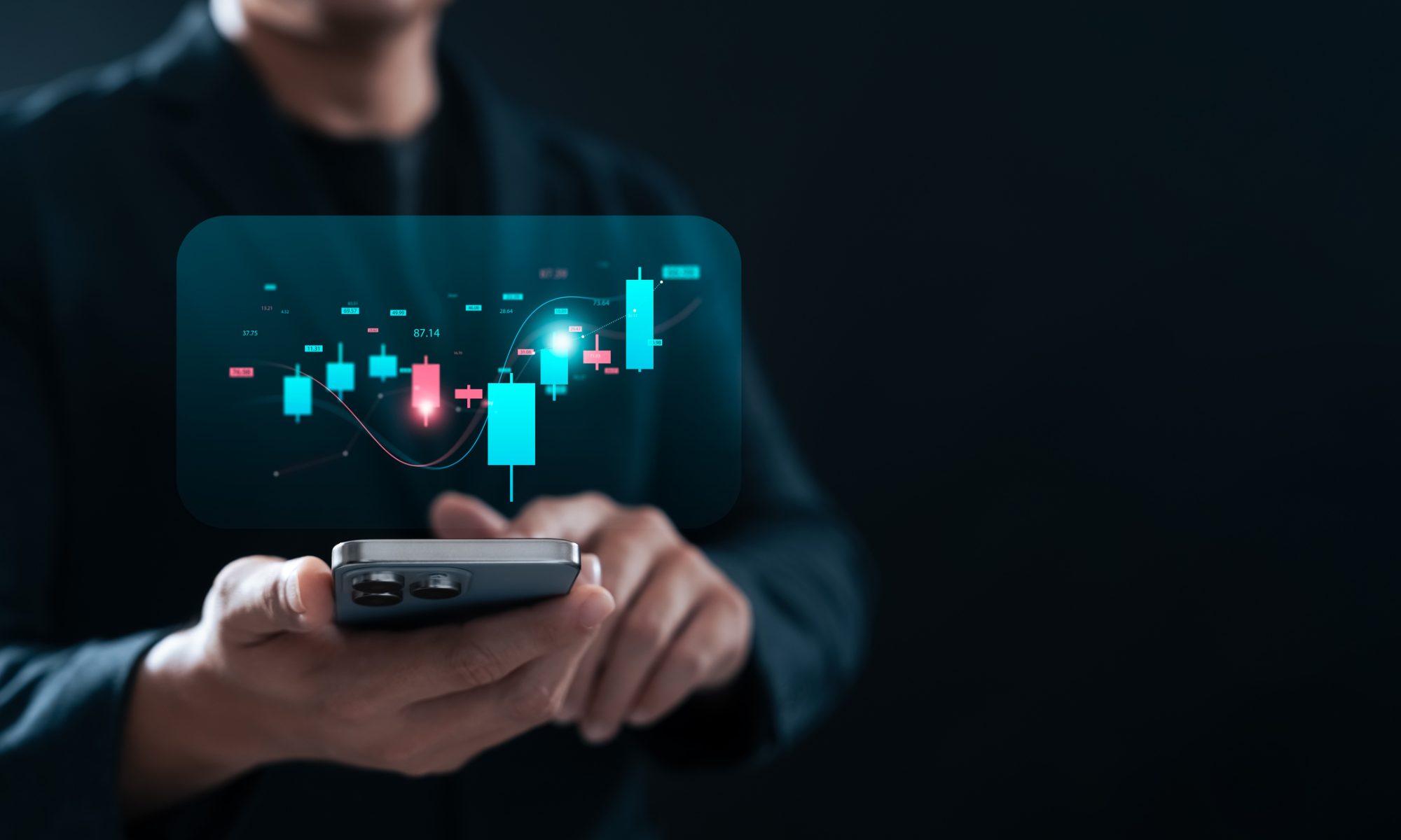 Investor using a smartphone to monitor stock-market charts, representing strong mid-day trading activity in new energy and electric vehicle stocks.