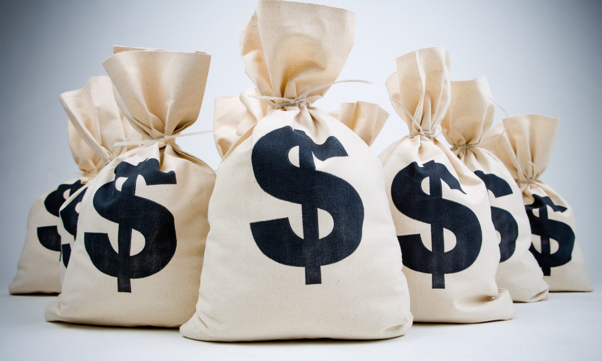 Money bags marked with dollar signs representing SunPower’s $26.2 million private equity financing to support growth and its push toward profitability.