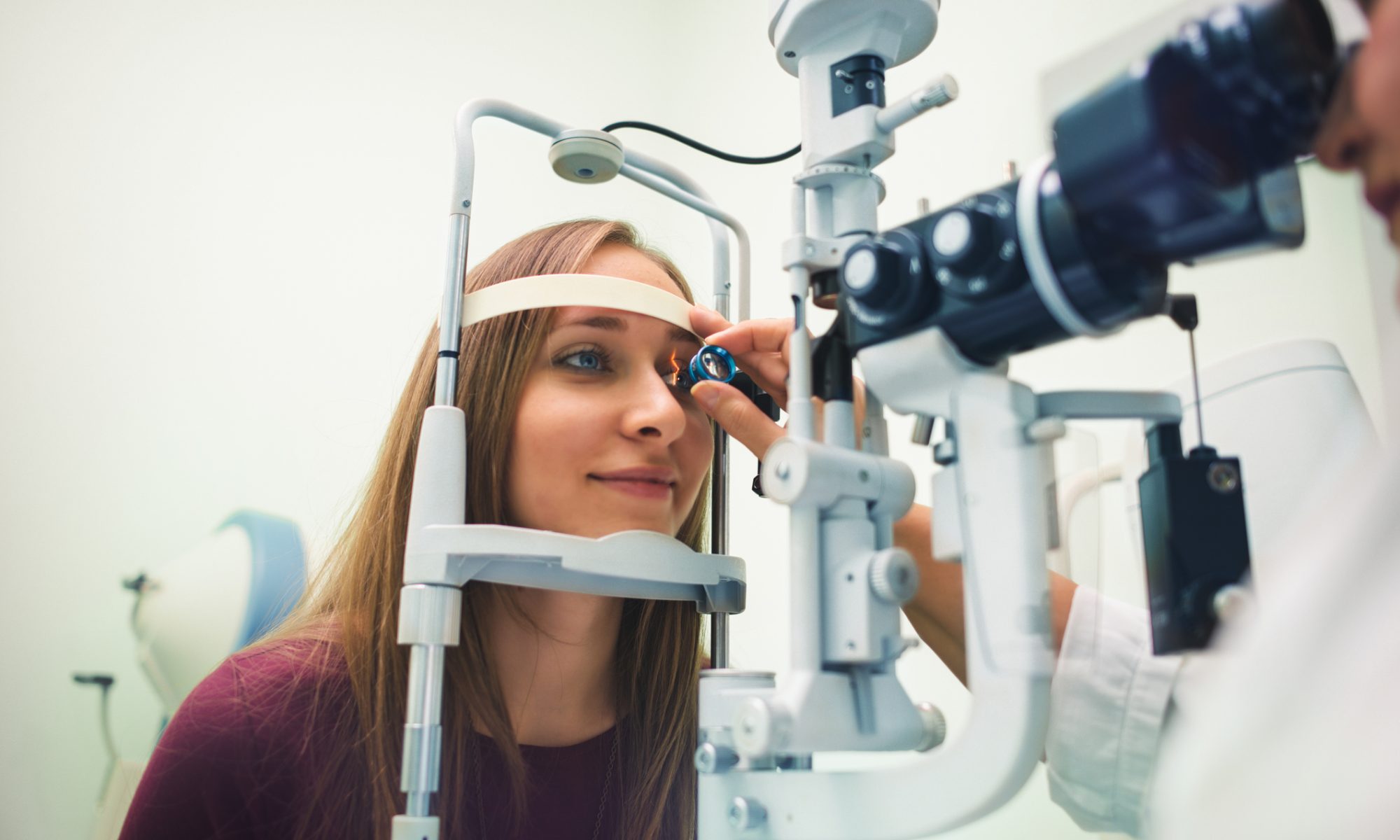 Patient undergoing an eye examination with ophthalmic equipment, representing clinical research into gene therapies for inherited retinal diseases.