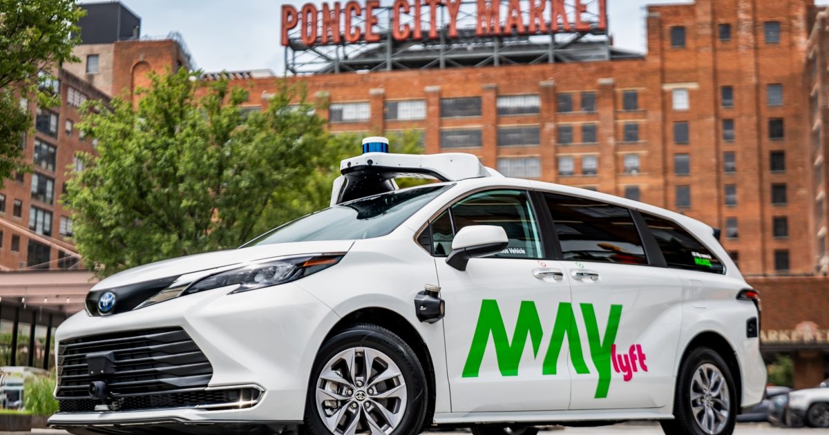 May Mobility autonomous minivan equipped with self-driving sensors in an urban setting, representing the company’s planned public-market debut through a SPAC merger.