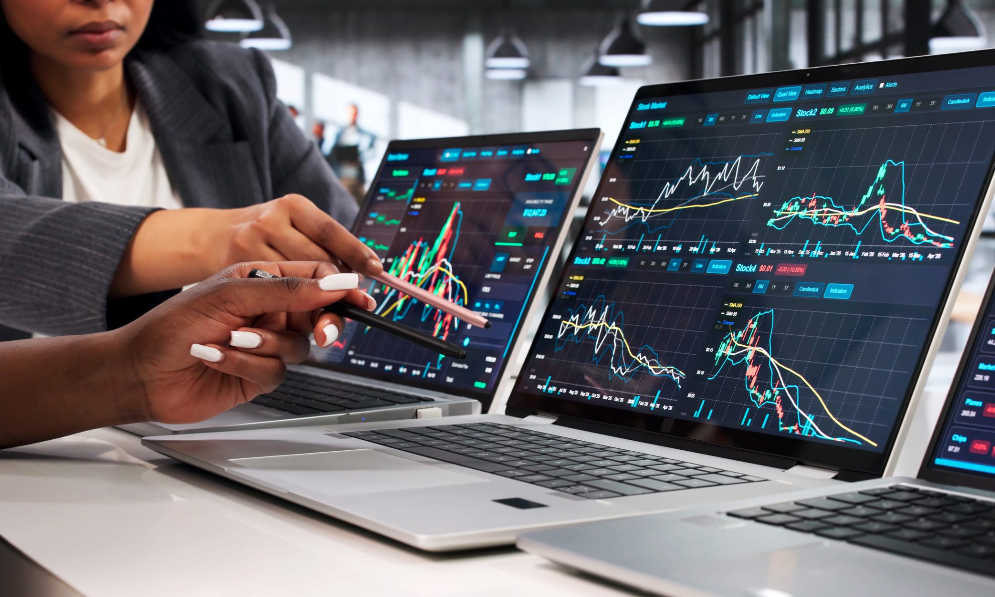 Investors reviewing stock charts across multiple computer screens, representing active trading in VistaGen Therapeutics and Surf Air Mobility.