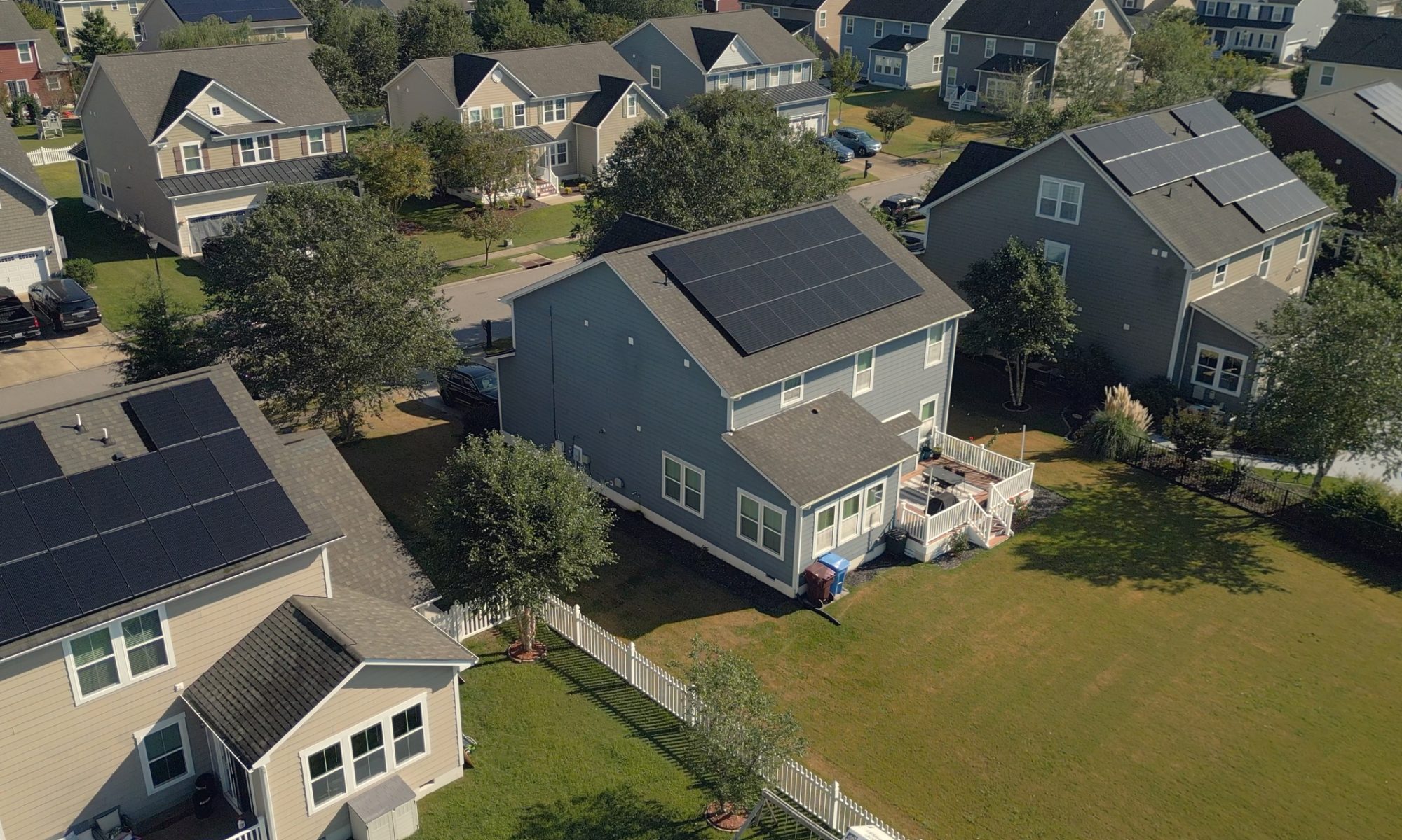 Aerial view of a residential neighborhood with rooftop solar panels, representing Sunrun and SPAN’s plan to integrate home energy systems with distributed AI computing infrastructure.